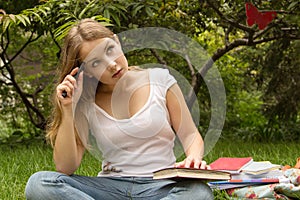 Portrait of college student with book thinking about exam