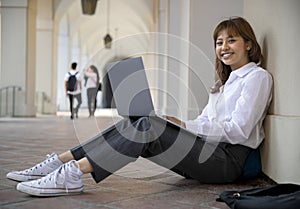 Portrait of a college student enjoying campus life, studying and researching, using computer technology