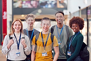 Portrait Of College Student Friends Meeting In Busy Communal Campus Building