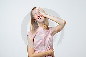 Portrait of comic caucasian girl laughing keeping eyes closed