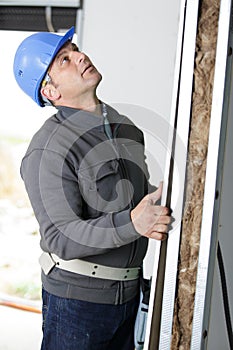 Portrait competent carpenter checking wood