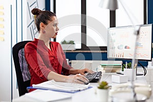 Portrait of concentrated entrepeneur working and analyzing financial charts photo
