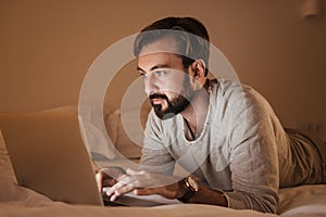 Portrait of a concentrated man using laptop computer