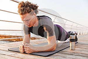 Portrait of a concentrated sportsman doing plank exercise
