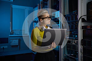 Portrait of concentrated woman coder solving problem in data center