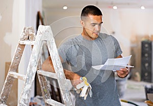 Portrait of a concentrated young man, studying a document