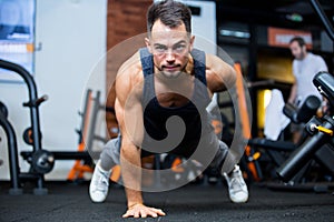 Portrait concentrated young sportsman doing plank exercise