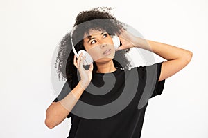 Portrait of concentrated young woman listening to music