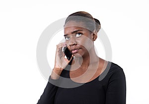 Portrait of concentrated young woman talking on mobile phone