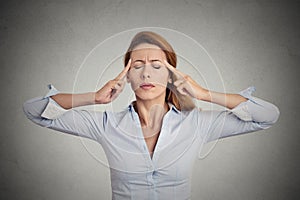 Portrait concentrating woman grey wall background.