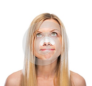 Portrait of concerned teenage girl with clear-up strips on nose