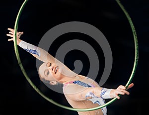 Portrait, concert with a gymnastics hoop and a woman in the gym for a performance showcase or practice. Training