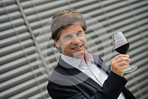 Portrait confidant vintner drinking red wine in winery