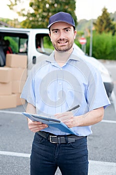 Portrait of confidence express courier and delivery van