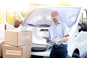 Portrait of confidence express courier and delivery van