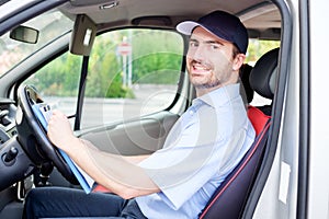 Portrait of confidence express courier on his delivery van