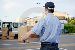 Portrait of confidence express courier next to his delivery van