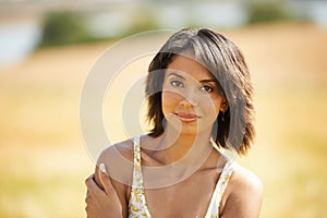 Portrait, confidence and woman in the countryside or field in summer outdoor, beauty and health. Face, young person at