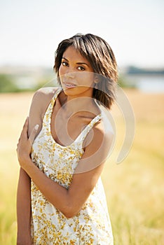 Portrait, confidence and woman in the countryside or field in summer outdoor, beauty and health. Face, young person at