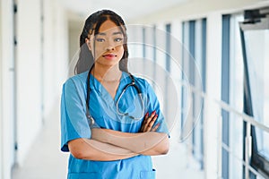 Portrait confident African American female doctor medical professional writing patient notes isolated on hospital clinic hallway