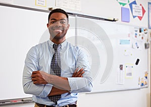 Portrait of confident African American male teacher in class photo