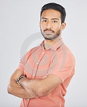 Portrait, confident and arms crossed with a serious asian man in studio on gray background. Fashion, mindset and pride