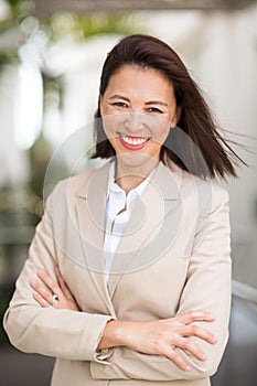 Portrait of a confident Asian businesswoman smiling.
