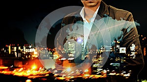 Portrait of a confident bearded businessman standing with his hands in pockets overlay night city landscape and world map backgro