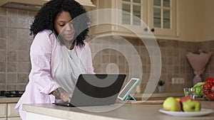 Portrait of confident beautiful freelancer discussing business strategy on phone messaging online on laptop and tablet