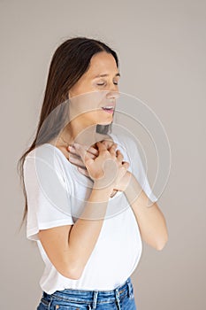 Portrait of confident beautiful woman with long brown hair, wearing casual clothes, standing in relaxed pose with hands