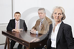 Portrait of confident business group at desk in office