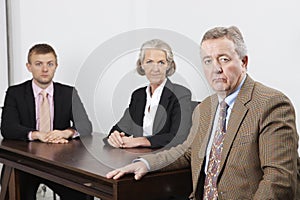 Portrait of confident business group at desk in office