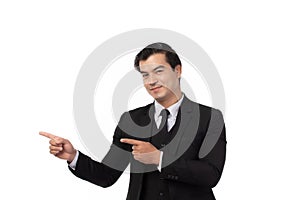 Portrait of a confident business man in black suit smile and pointing to copy space isolated on white background. Portrait
