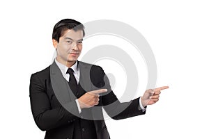 Portrait of a confident business man in black suit smile and pointing to copy space isolated on white background. Portrait