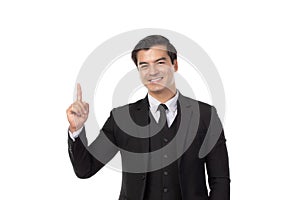 Portrait of a confident business man in black suit smile and pointing to copy space isolated on white background. Portrait