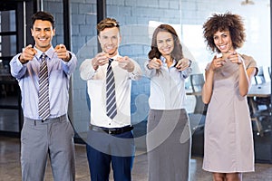 Portrait of confident business team pointing in office