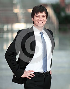 Portrait of confident businessman on background of a blurred office.