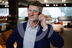 Portrait of a confident businessman, entrepreneur, sales manager, retail assistant, interior designer talking on mobile phone