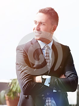 Portrait of confident businessman looking out the window of the