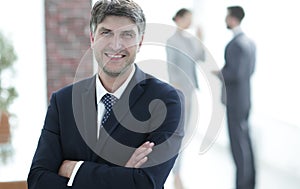 Portrait of confident businessman on office background