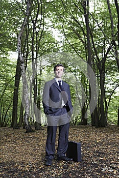 Portrait Of Confident Businessman Standing In Forest