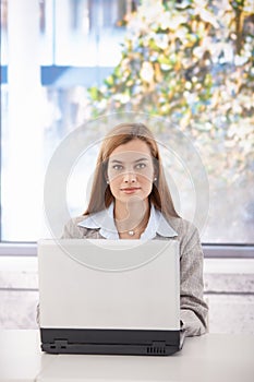 Portrait of confident businesswoman with laptop