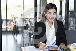 Portrait of a confident businesswoman smiling and looking at camera at meeting room, business concept