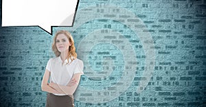 Portrait of confident businesswoman standing arms crossed with speech bubble against brick wall