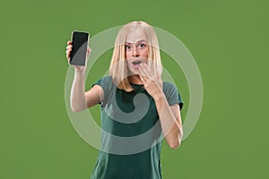 Portrait of a confident casual girl showing blank screen mobile phone