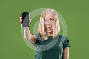 Portrait of a confident casual girl showing blank screen mobile phone