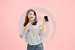 Portrait of a confident casual girl showing blank screen mobile phone