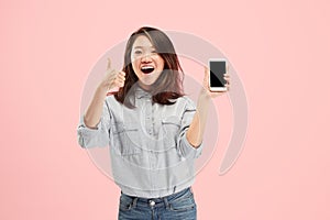 Portrait of a confident casual girl showing blank screen mobile phone