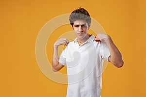 Portrait of confident cool guy on yellow background