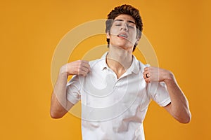 Portrait of confident cool guy on yellow background